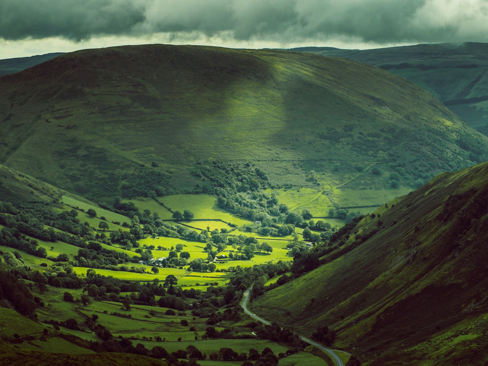 A green Welsh valley between steep hillsides