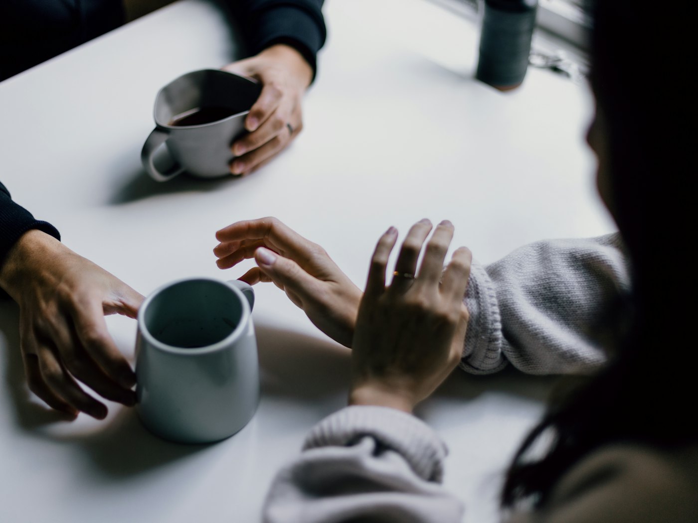 Two people talking over coffee