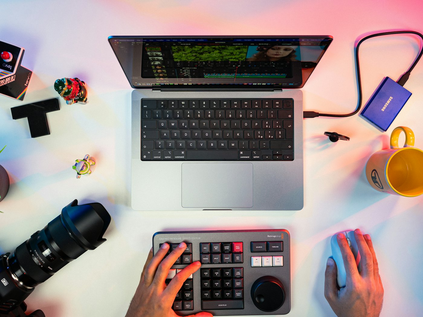 A creator's desk with a laptop, camera and editing kit