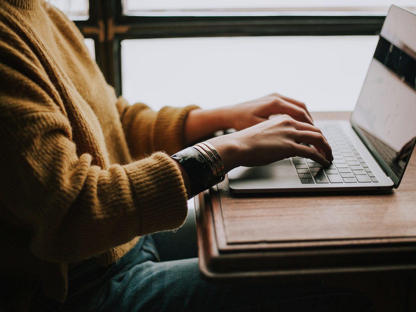 A business owner working on their own website at a laptop